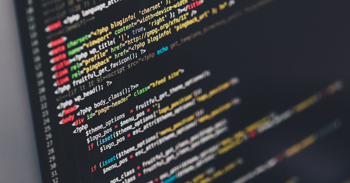 Laptop showing code on a desk